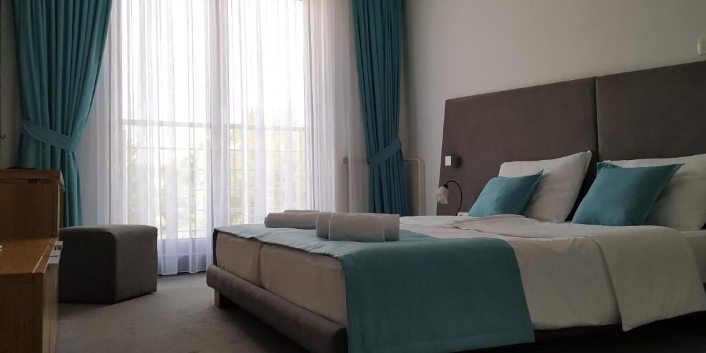 Deluxe Double Room at Hotel Vukov Most with a king bed and large window